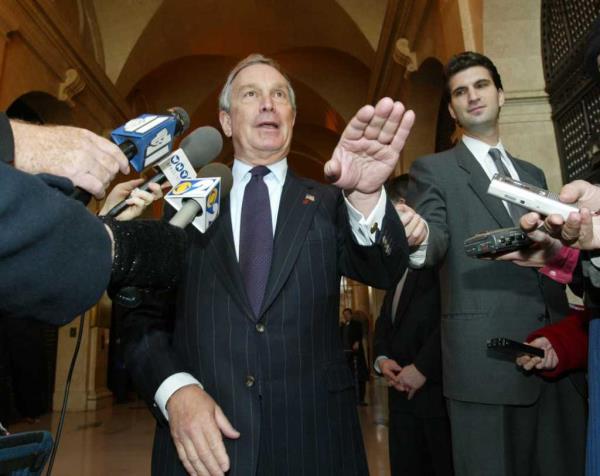 Michael Bloomberg, a man in a suit talking to media at Municipal building after being sworn in as mayor-elect.