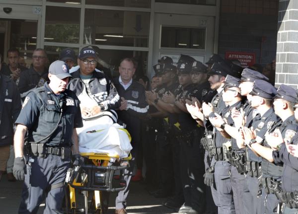 Officer stand outside the hospital. 