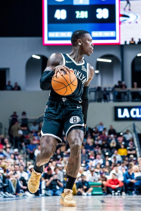 Dennis Schroder dribbles during a preseason game for the Nets.