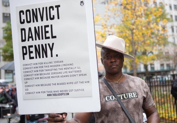 A protester holds a sign that says 