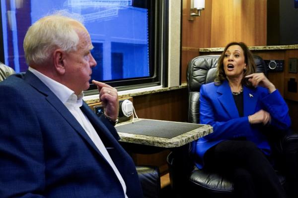 U.S. Democratic vice presidential candidate Minnesota Governor Tim Walz and Democratic presidential candidate and U.S. Vice President Kamala Harris talk at the campaign bus, as Harris and her running mate Walz make a four-stop bus tour of western Pennsylvania before heading to Chicago for the Democratic Natio<em></em>nal Convention, in Rochester, Pennsylvania, U.S., August 18, 2024.