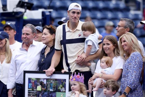 John Isner of the United States celebrates with his family after beating Facundo Diaz Acosta of Argentina at the U.S. Open on Tuesday.