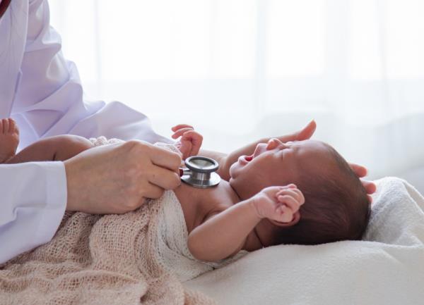 Asian newborn baby get sick crying during examine by pediatrician