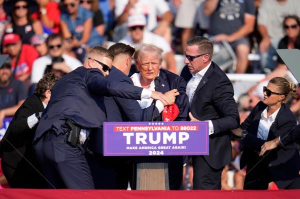 Republican presidential candidate former President Do<em></em>nald Trump is helped off the stage at a campaign event in Butler, Pa.