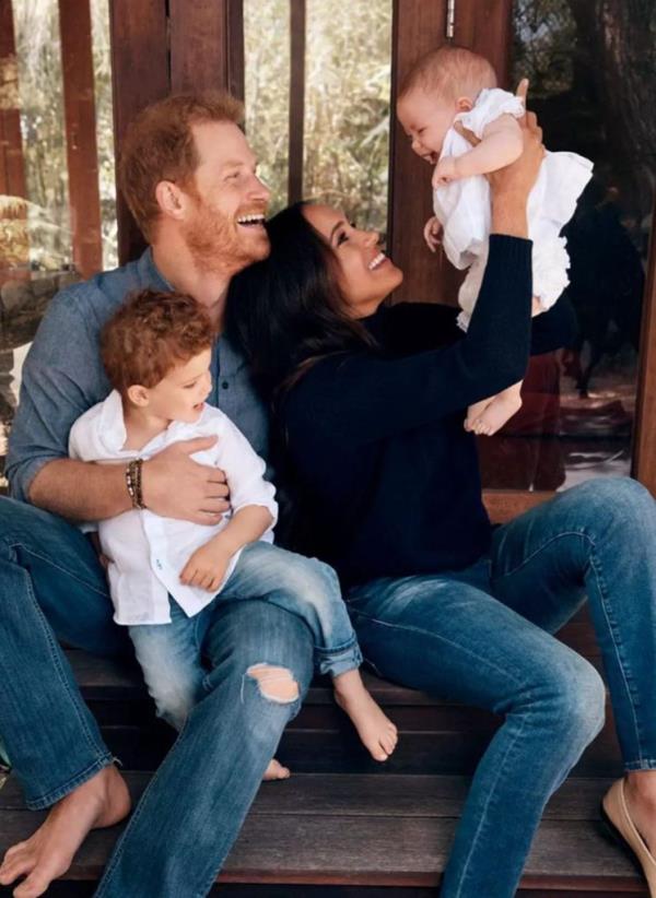 Prince Harry and Meghan Markle holding their children, Lilibet and Archie, during the Queen's Platinum Jubilee celebrations