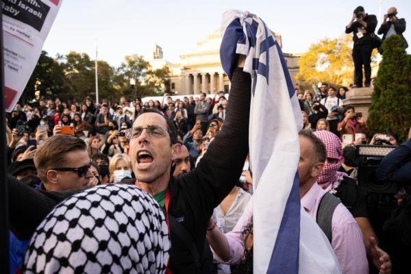 A pro-Israel demo<em></em>nstrator shouts at Palestinian supporters during a protest at Columbia University, Thursday, Oct. 12, 2023, in New York.