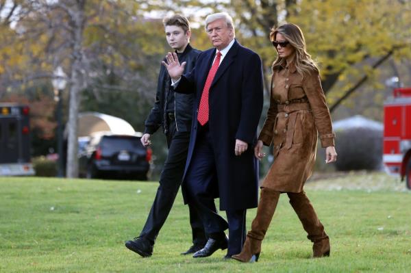 Do<em></em>nald Trump, first lady Melania Trump and their son Barron Trump walk across the South Lawn before leaving the White House on board Marine One November 26, 2019 in Washington, DC.