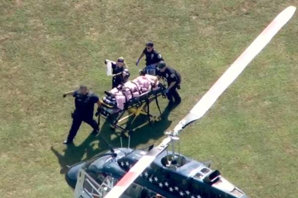 An injured person being rushed out of Apalachee High School.