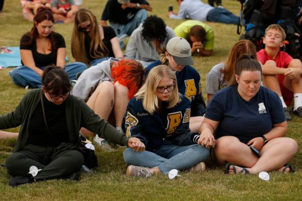 Apalachee High School students hold hands at a prayer vigil for the shooting victims on Sept. 4, 2024.