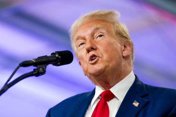 Former U.S. President Do<em></em>nald Trump delivering a speech at a campaign event in Howell, Michigan, discussing crime and safety.