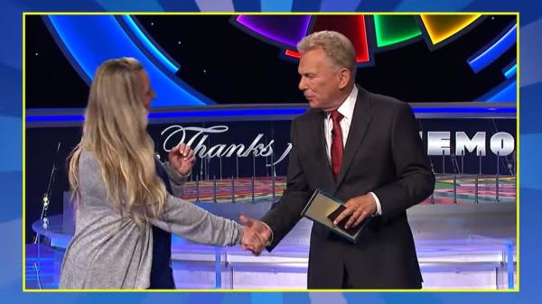 Pat Sajak shakes hands with co<em></em>ntestant Allison