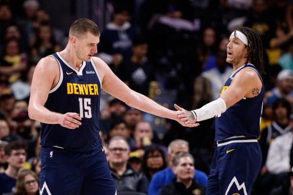 Nikola Jokic reacts with forward Aaron Gordon in the second quarter.