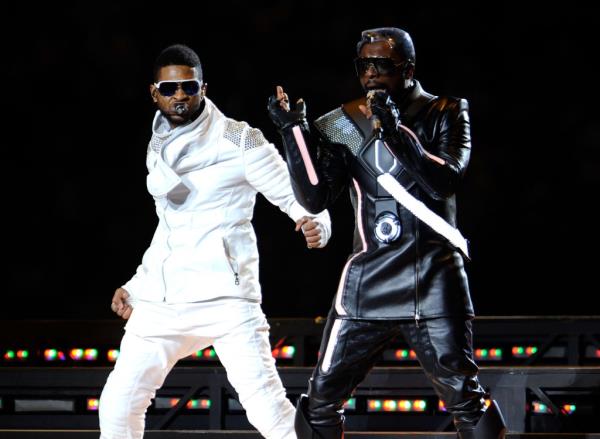 Usher performs with will.i.am of The Black Eyed Peas during the Bridgestone Super Bowl XLV Halftime Show at Dallas Cowboys Stadium on February 6, 2011 in Arlington, Texas.