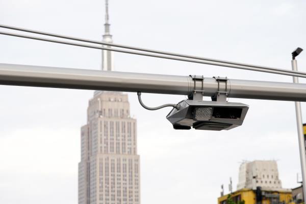 A general view of a co<em></em>ngestion pricing toll gantry with the Empire State Building behind it as seen on W40th Street in New York, NY on June 5, 2024. 