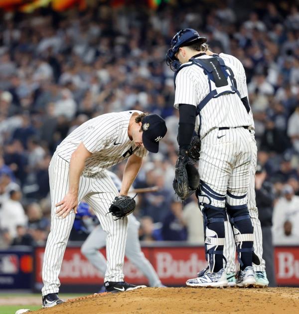 Gerrit Cole and Austin Wells of the New York Yankees discussing on the mound after a two-run RBI double by Teoscar Hernández during the fifth inning of the World Series game against the Los Angeles Dodgers