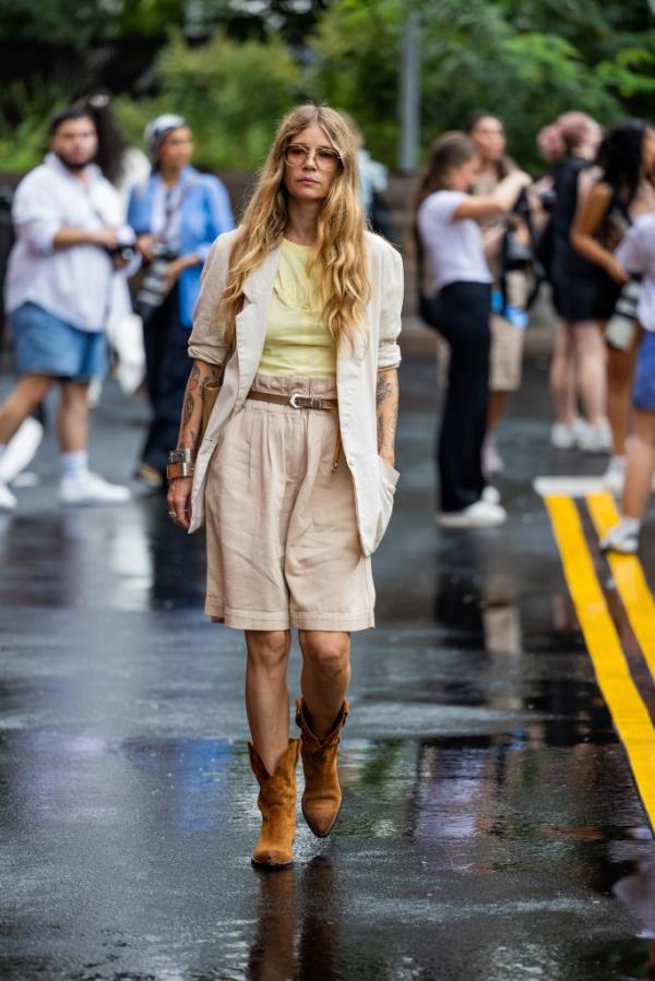 A guest wearing beige shorts and a button shirt outside Ulla Johnson during New York Fashion Week in September 2023