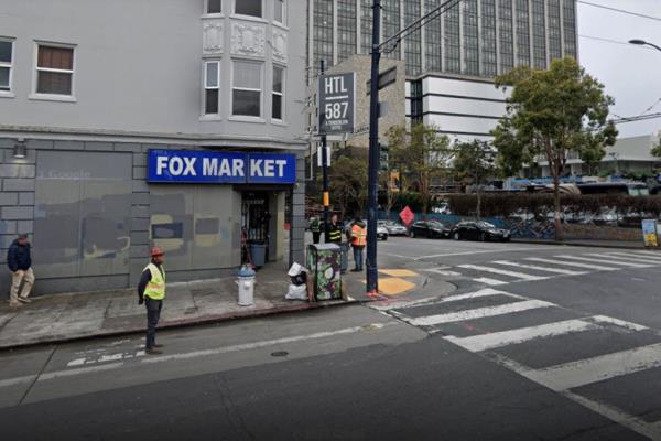 The former hotel on a streetcorner in San Francisco wher<em></em>e homeless people can get free drinks. The gray building houses the Fox Market on the first floow.