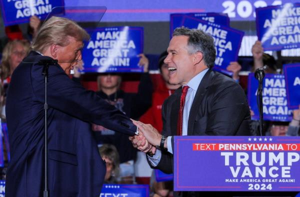 Former President Do<em></em>nald Trump shaking hands with Senate candidate Dave McCormick at a campaign rally in Erie, Pennsylvania