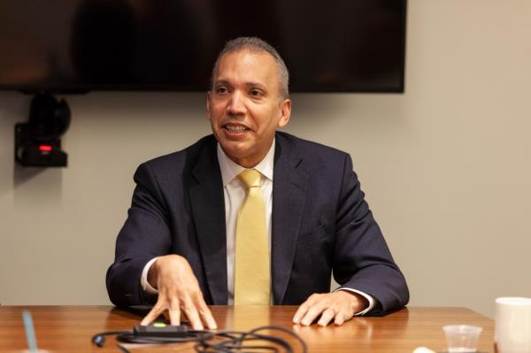 Louis Molina at a desk