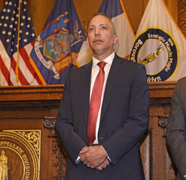 Louis Molina standing with his arms crossed