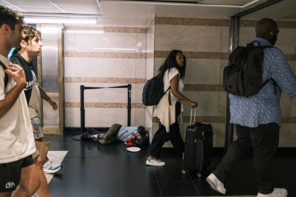 A man sleeping in a corner at Penn Station on Aug. 22, 2024.