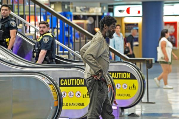 A homeless man getting off the escalator at Penn Station on Aug. 27, 2024.