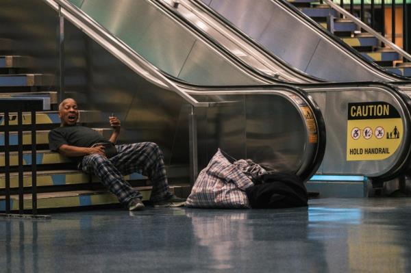 A homeless man blocking a staircase inside Penn Station on Aug. 24, 2024.