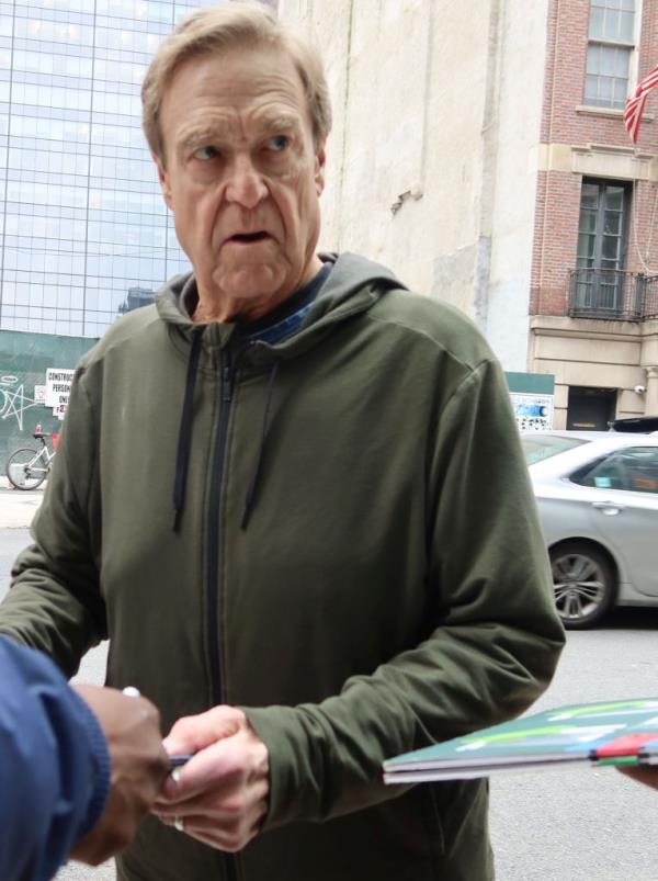 Goodman stops for fans and signs autographs in midtown New York City.