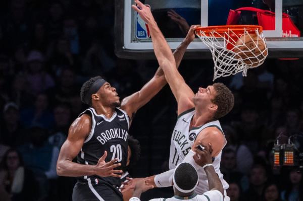 Nets center Day'Ron Sharpe (20) dunks over Milwaukee Bucks center Brook Lopez (11) in the first half at Barclays Center on Dec. 27.