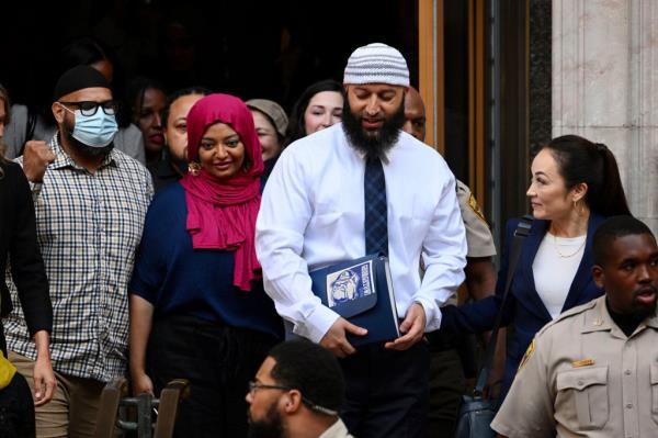 Adnan Syed, center right, leaves the courthouse after a hearing on Sept. 19, 2022, in Baltimore. 