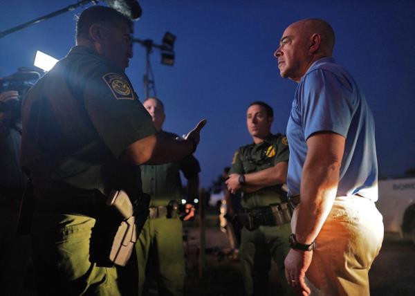 DHS Secretary Alejandro Mayorkas listens to Border Patrol Chief Raul Ortiz near the border with Mexico in La Joya, Texas.