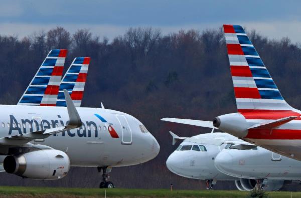 Photo of two parked American Airlines planes. 