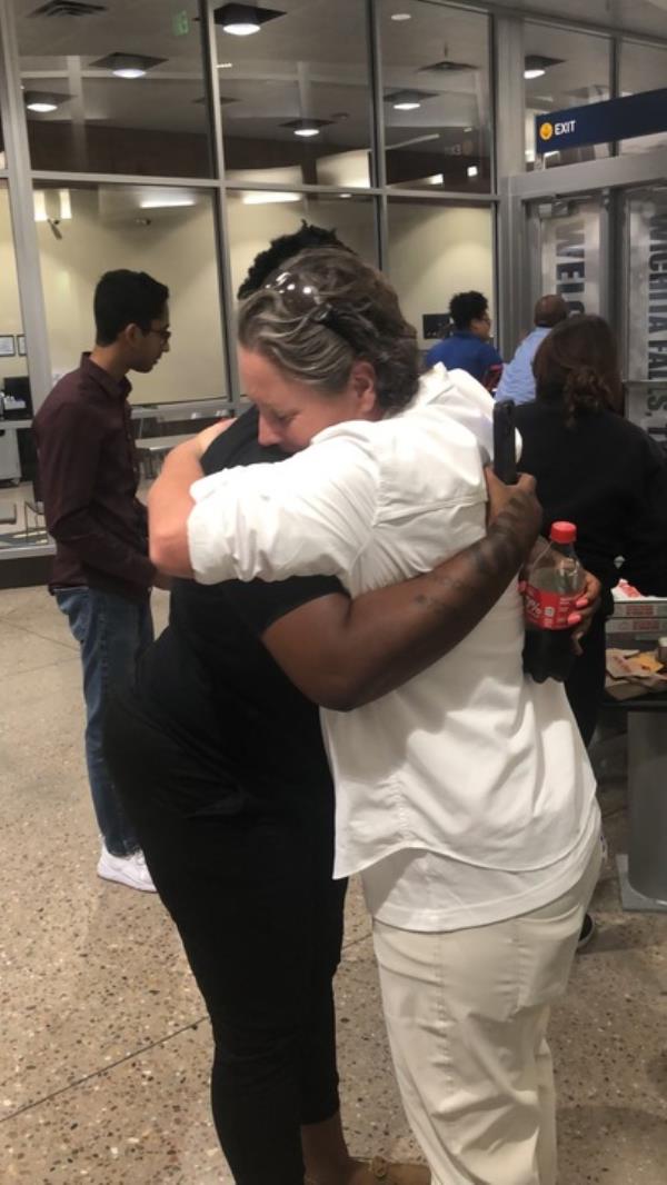 Photo of two women hugging each other. 