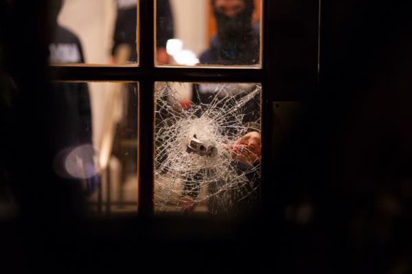 Students smash through a building window