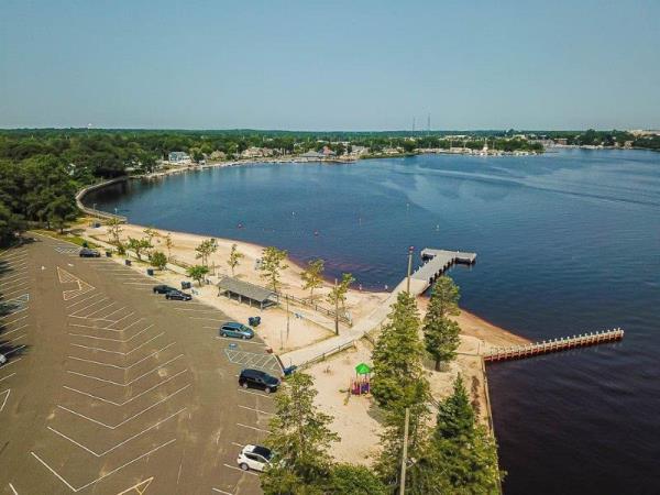 An aerial view of Beachwood Beach West, including the nearly empty parking lot and a pier stretching into the water, in Beachwood, New Jersey.