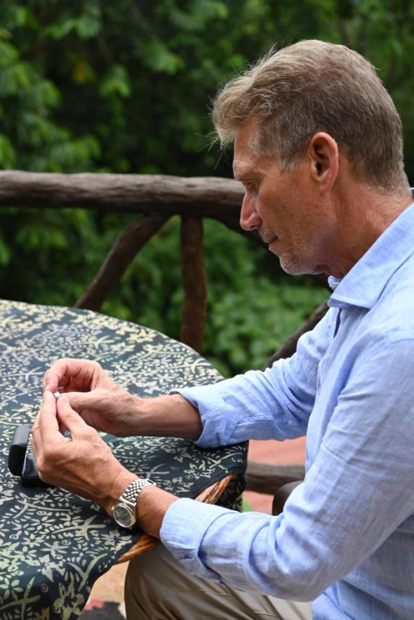 Gerry Turner kneeling with a ring. 