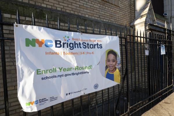 A sign advertising 3-K and pre-K program on a fence outside St. Joseph the Worker Catholic Academy in Brooklyn, NY.