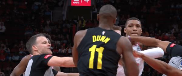 Jabari Smith Jr. and Kris Dunn exchange punches. 