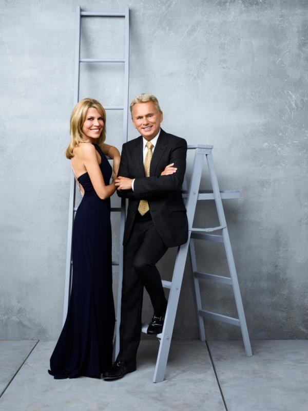 Photo of Vanna White and Pat Sajak on a ladder. 