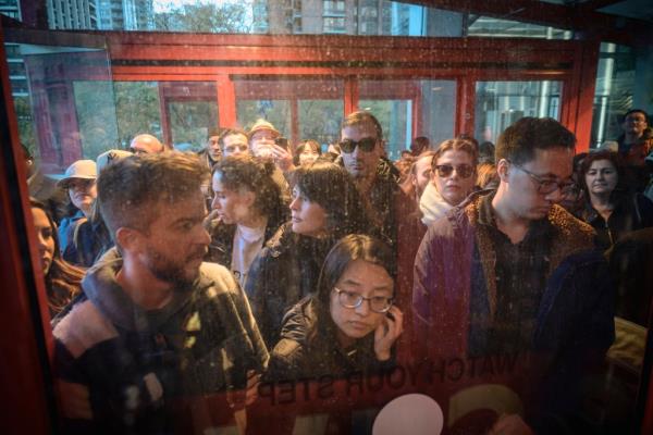 Crowd of people cram on line to Roosevelt Island tram. 