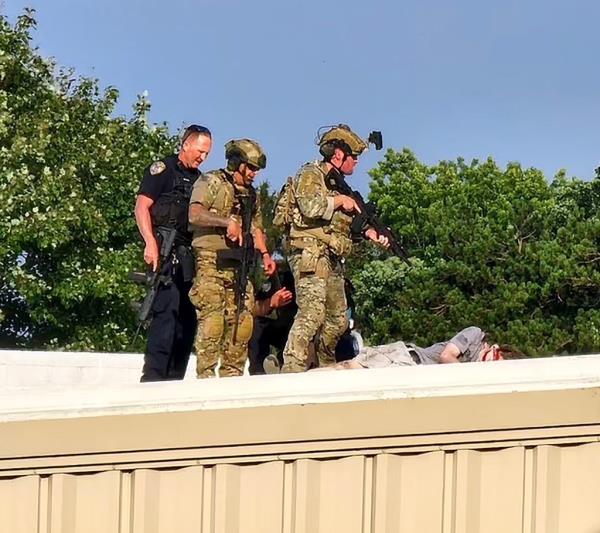 Crooks opened fire from the American Glass Research building rooftop. 