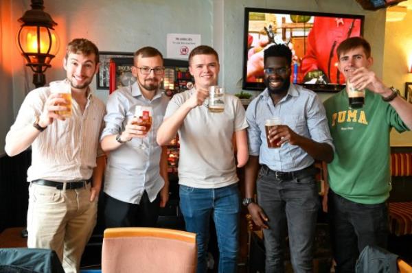 Jon May,25, set himself a challenge to drink 2000 pints in 200 days and he celebrates with his final pint at The Market Tavern in Atherstone. (L-R) Owen Beresford,22 from Kettering, Jon May,25, Benjamin Turrell,19 from South East London, Tolu Opaleye,20 from Loughborough and George Lewington,18 from South East Lo<em></em>ndon - Tik Tok followers. October 20, 2023. Photo released - October 20 2023. See SWNS story SWNJpints. A beer-lover has completed an epic drinking challenge to sink 2,000 pints in 200 days - costing him a staggering 18,000. Jon May has been necking 10 pints a day for the past six-and-a-half mo<em></em>nths and says he hasn't had a single hangover so far. The 25-year-old decided to embark on the marathon pub crawl after seeing someone on Tiktok trying to drink 1,000 pints in a year. He recko<em></em>ned he could stomach double the amount and today (Fri) completed his beer-drinking quest at The Market Tavern in Atherstone, Warks. Jon has mainly been drinking in dozens of boozers around his home town of Guildford, Surrey, and has been docu<em></em>menting his progress on Tiktok. While carrying out his challenge, which has seen him co<em></em>nsume more than 360,000 calories, his number of followers has risen from 6,000 to 123,000. Tiktok influencer Jon reckons he has forked out around 8,000 on lager and cider and a further 10,000 on catching Ubers to and from the pub.