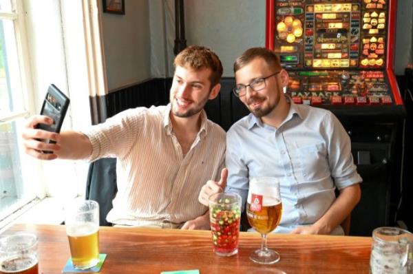 Jon May,25, set himself a challenge to drink 2000 pints in 200 days and he celebrates with his final pint at The Market Tavern in Atherstone. Havin<em></em>g a selfie with Tik Tok fan Owen Beresford,22, from Kettering. October 20, 2023. Photo released - October 20 2023. See SWNS story SWNJpints. A beer-lover has completed an epic drinking challenge to sink 2,000 pints in 200 days - costing him a staggering 18,000. Jon May has been necking 10 pints a day for the past six-and-a-half mo<em></em>nths and says he hasn't had a single hangover so far. The 25-year-old decided to embark on the marathon pub crawl after seeing someone on Tiktok trying to drink 1,000 pints in a year. He recko<em></em>ned he could stomach double the amount and today (Fri) completed his beer-drinking quest at The Market Tavern in Atherstone, Warks. Jon has mainly been drinking in dozens of boozers around his home town of Guildford, Surrey, and has been docu<em></em>menting his progress on Tiktok. While carrying out his challenge, which has seen him co<em></em>nsume more than 360,000 calories, his number of followers has risen from 6,000 to 123,000. Tiktok influencer Jon reckons he has forked out around 8,000 on lager and cider and a further 10,000 on catching Ubers to and from the pub.