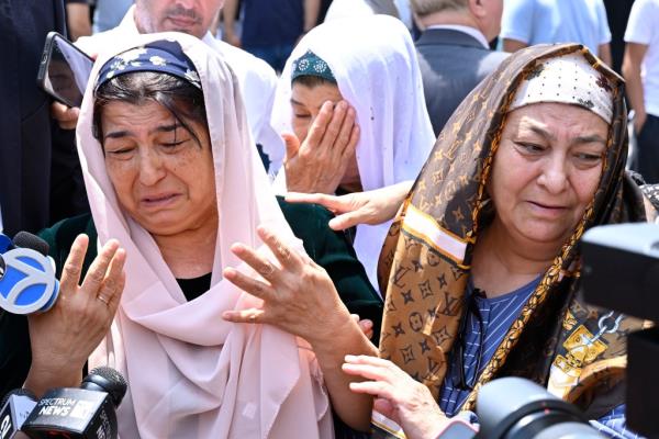 Family members grieve at the funeral for Faridun Mavlonov, 15.