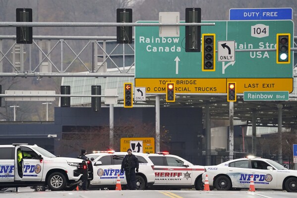 Law enforcement perso<em></em>nnel block off the entrance to the Rainbow Bridge, Wednesday, Nov. 22, 2023, in Niagara Falls, N.Y. The border crossing between the U.S. and Canada has been closed after a vehicle exploded at a checkpoint on a bridge near Niagara Falls. The FBI's field office in Buffalo said in a statement that it was investigating the explosion on the Rainbow Bridge, which co<em></em>nnects the two countries across the Niagara River. (Derek Gee/The Buffalo News via AP)