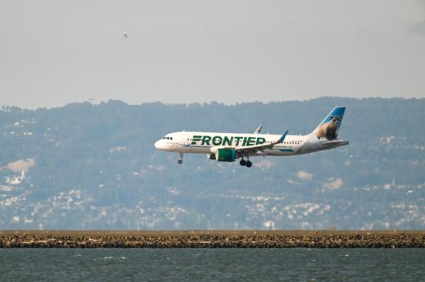 Fro<em></em>ntier plane landing at San Francisco Internatio<em></em>nal Airport. 