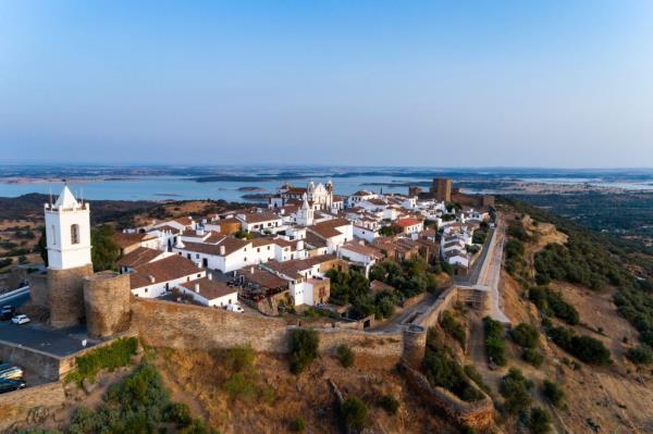 Aerial view of the historic village of Mo<em></em>nsaraz in Alentejo, Portugal with white buildings on a hill