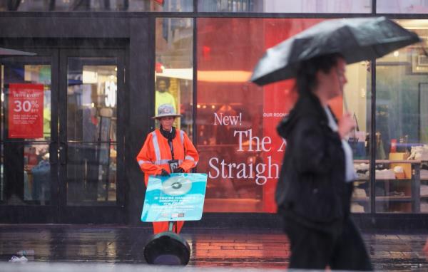 A Times Square Security Officer working in the rain in Times Square at Duffy Plaza in Manhattan.