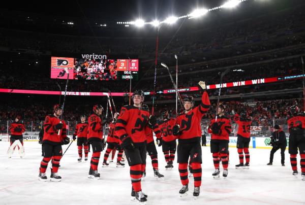 The Devils celebrate and acknowledge the fans after their win over the Flyers in their NHL Stadium Series battle.