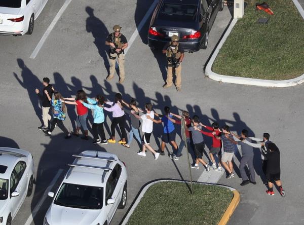 Kids are pulled out of Marjory Sto<em></em>neman Douglas High School after the 2018 shooting that left 17 dead and another 17 wounded.